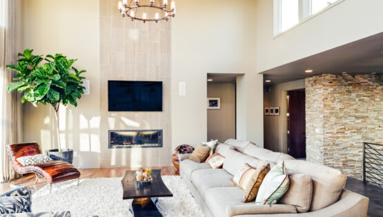 Image is of a modern smart home with a beige-colored living room and furniture.