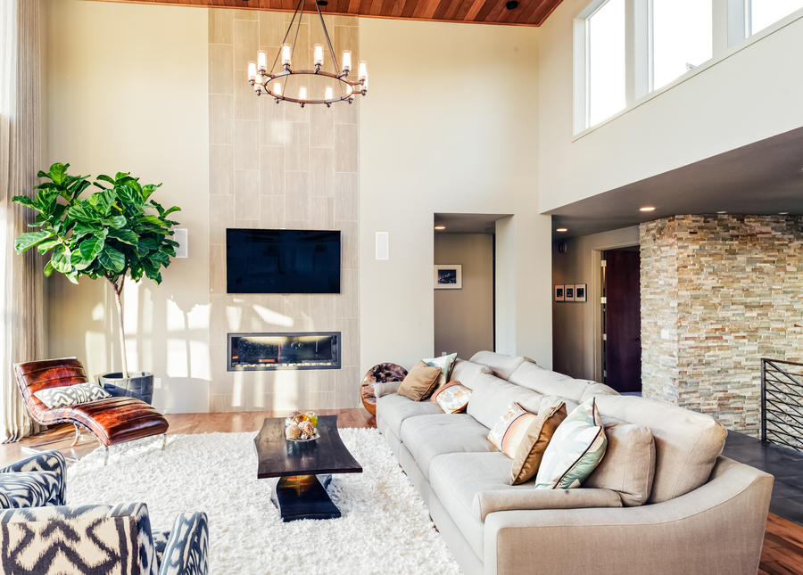 Image is of a modern smart home with a beige-colored living room and furniture.