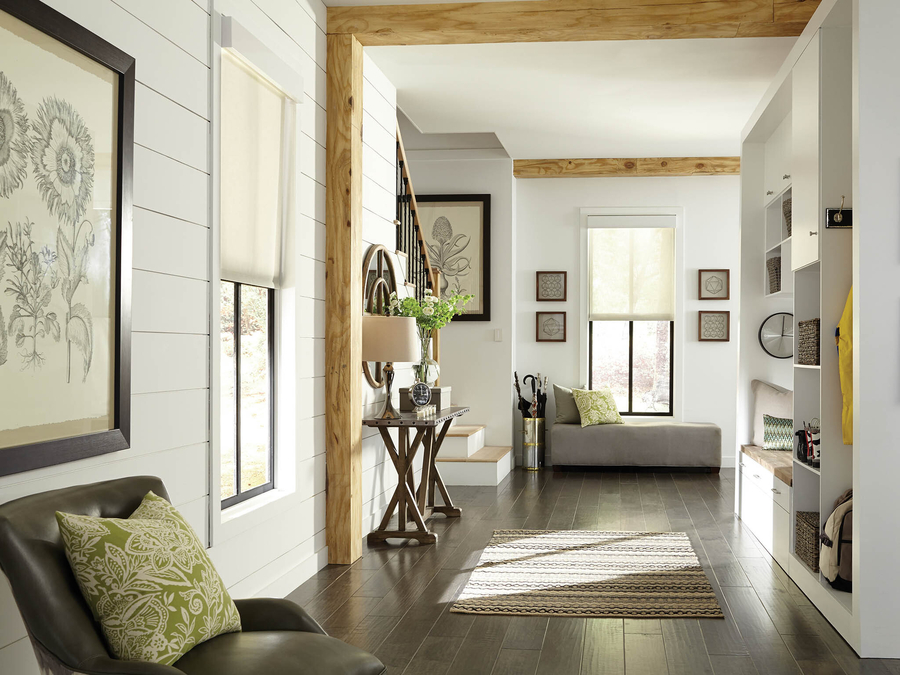 A home’s living area with Lutron motorized shades partially lowered and sunlight filtering through the windows.