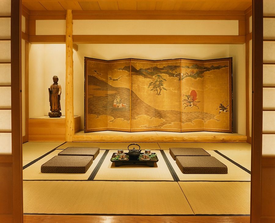 Japanese tea room in warm, yellow-hued lighting that feels cozy