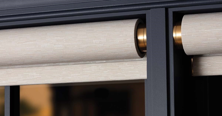 Close-up of a Lutron Palladiom roller and gold bracket installed within the window frame.